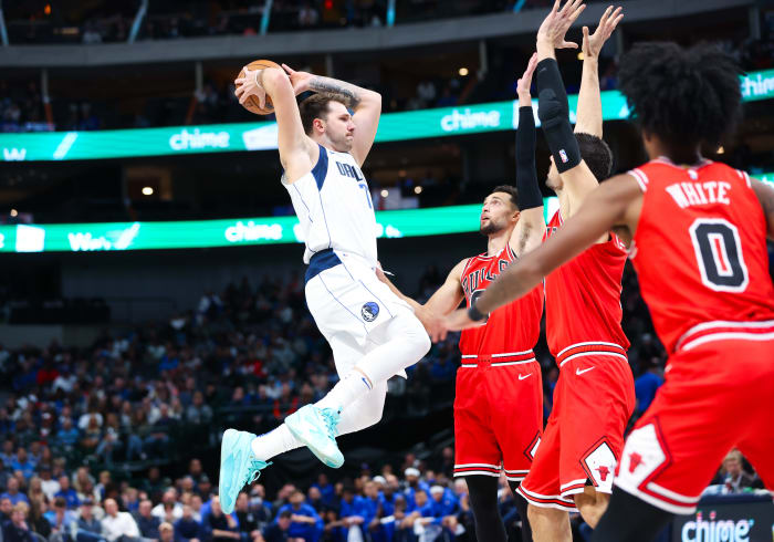 Dallas Mavericks superstar Luka Doncic takes flight as three Chicago Bulls look on.